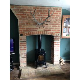 Exposed brick chimney breast and reclaimed pamments