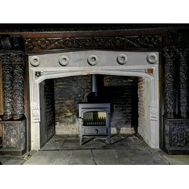 Clearview Vision 500 8kw stove. Antique historic enormous carved oak mantel in a listed hall. 