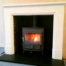 Clearview Vision 500 8kw stove. Aegean limestone mantel, riven slate chamber set and honed granite hearth. 