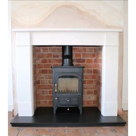 Clearview Pioneer 400 5kw stove. We rebuilt the brickwork inside the recess and fitted a boxed and lipped honed slate hearth and a capital fireplaces 54 inch Hersham mantel in Aegean limestone. 